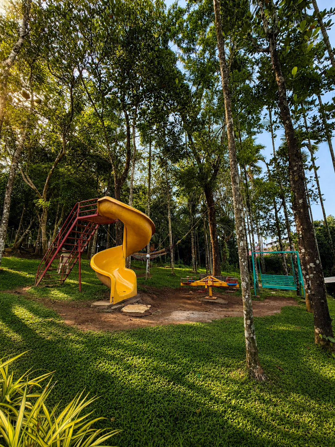 A kids park with swings and slides