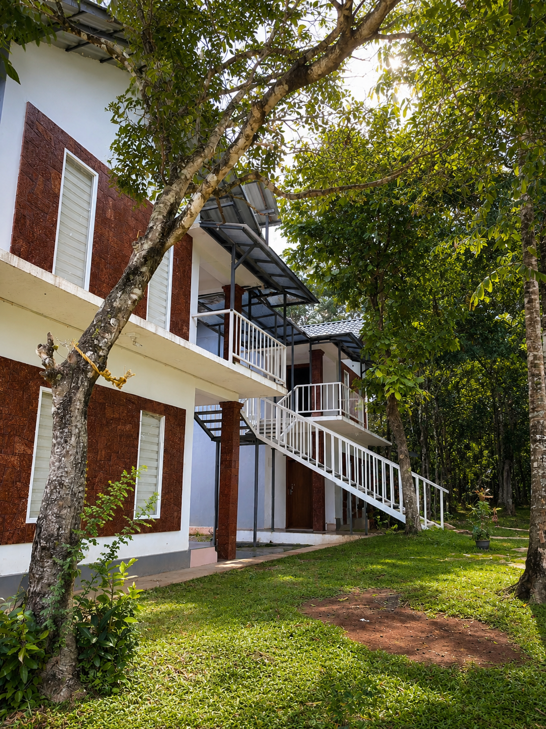Premium villa exterior with garden and staircase by day