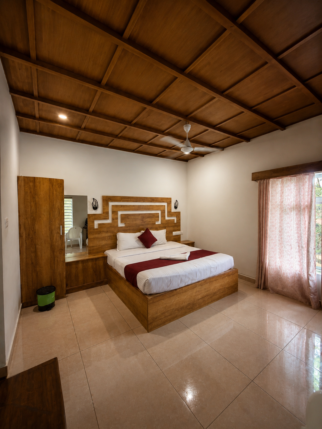 Premium bedroom with a coffered-wood ceiling and carved headboard