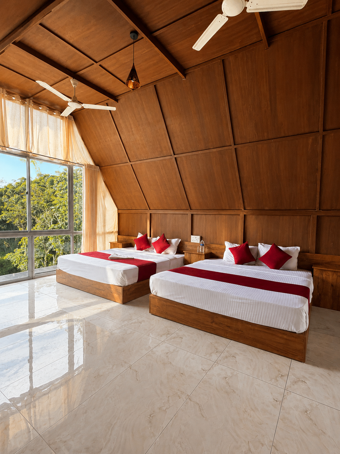 Bright A-frame room with two beds and forest-facing windows