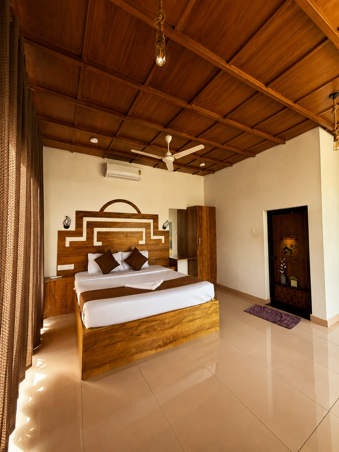 Spacious bedroom with a carved wooden headboard