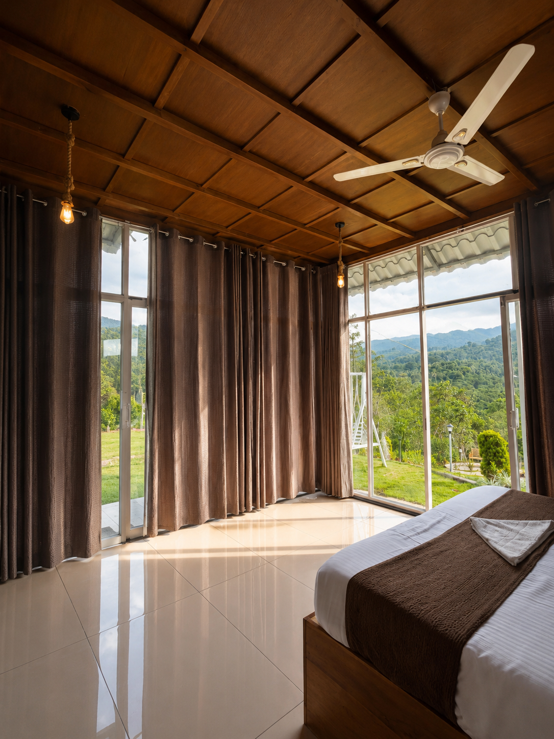 Floor-to-ceiling glass walls opening onto a panoramic valley view